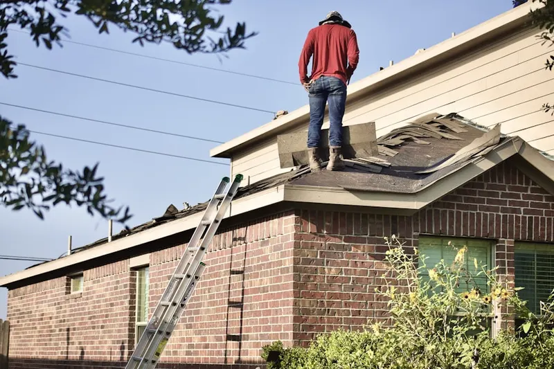 Professional roofer working on a residential roof in River Park
